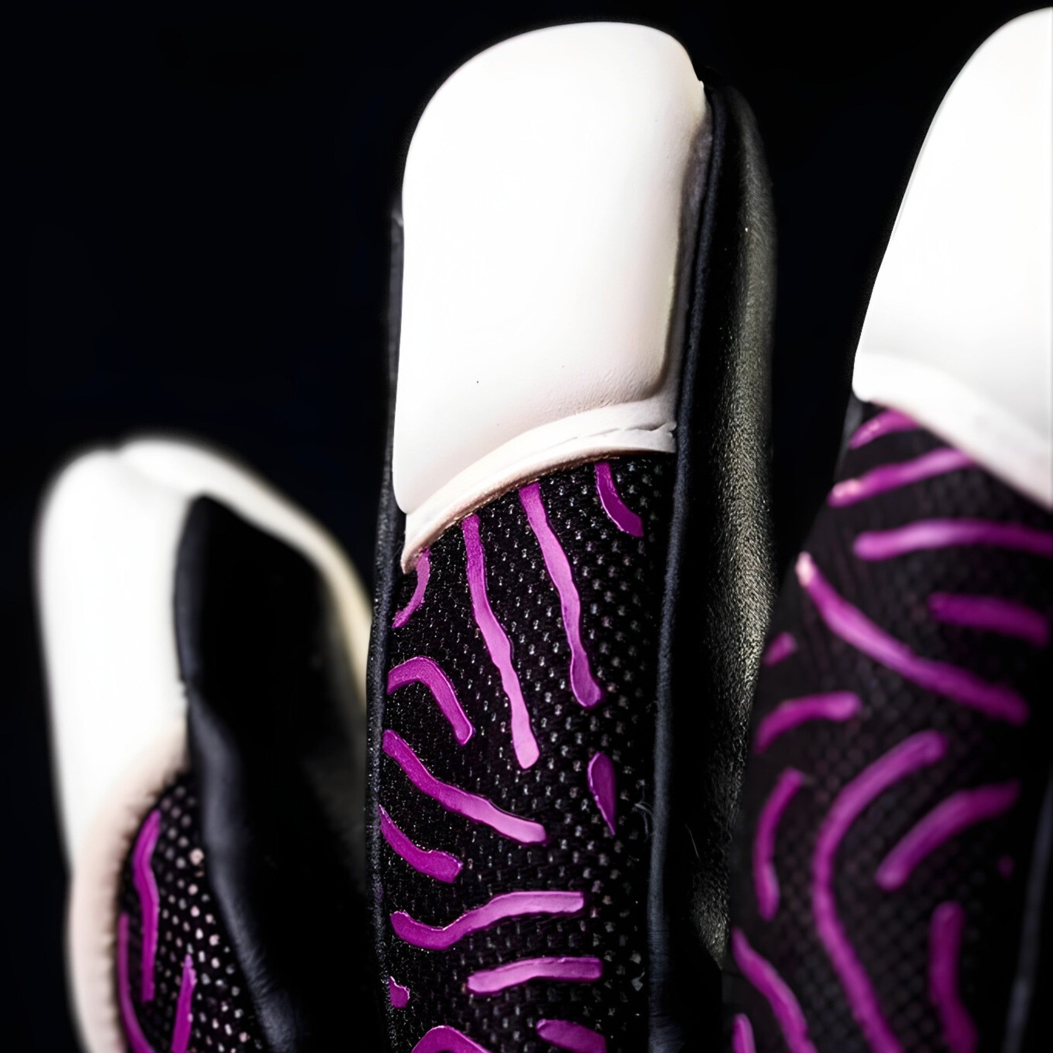 Close-up of N1 Zeus 2.0 Phoenix finger detailing the snug Vapor Negative Cut and professional stitching for a second-skin fit.