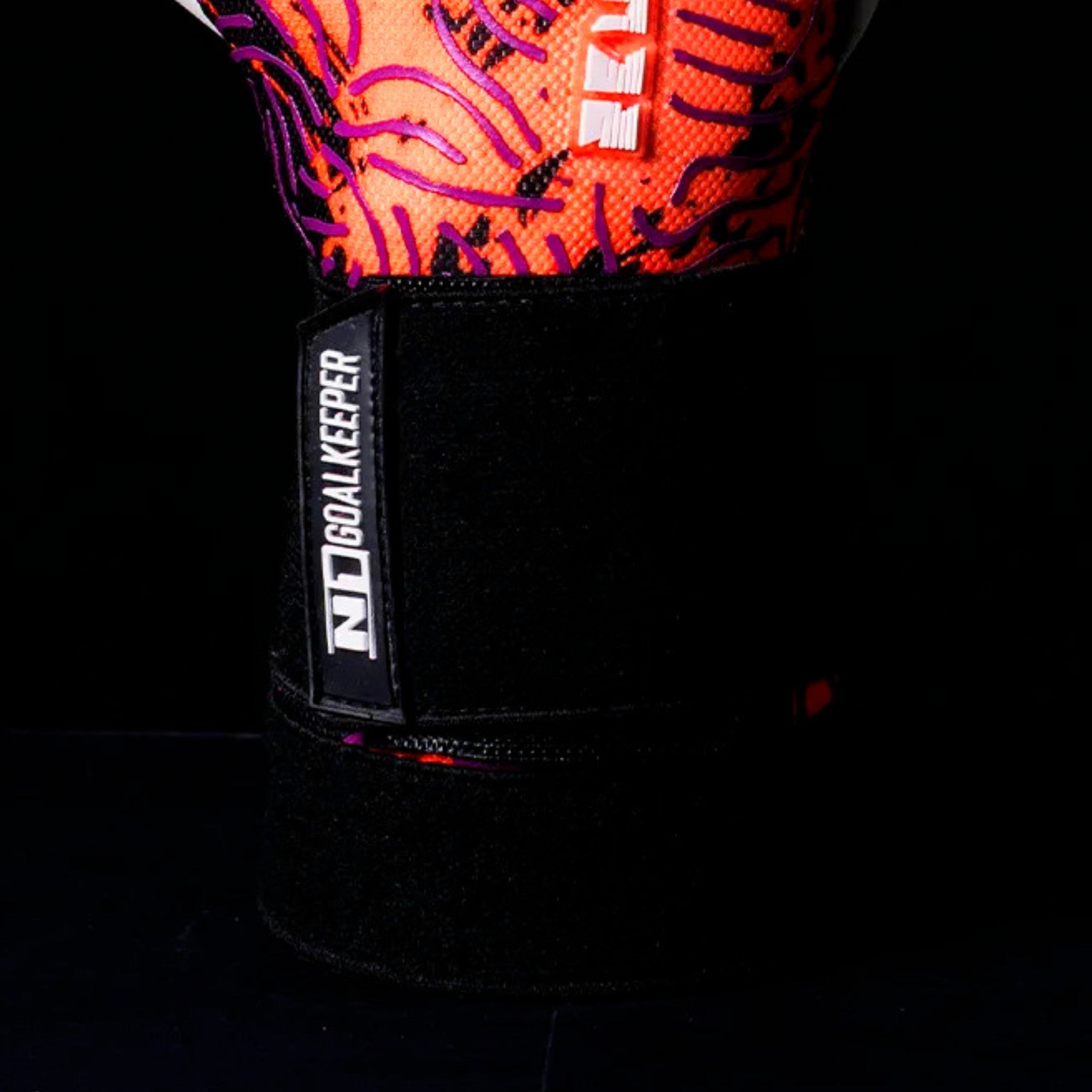 Close-up of N1 Zeus 2.0 Phoenix goalkeeper glove wrist strap featuring a professional elastic closure system for a secure and adjustable fit.